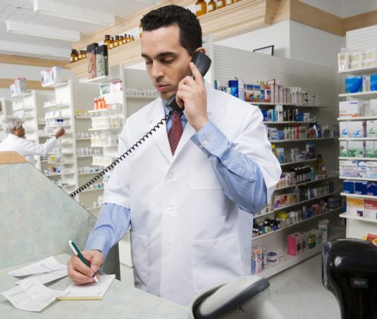 Pharmacist using a phone